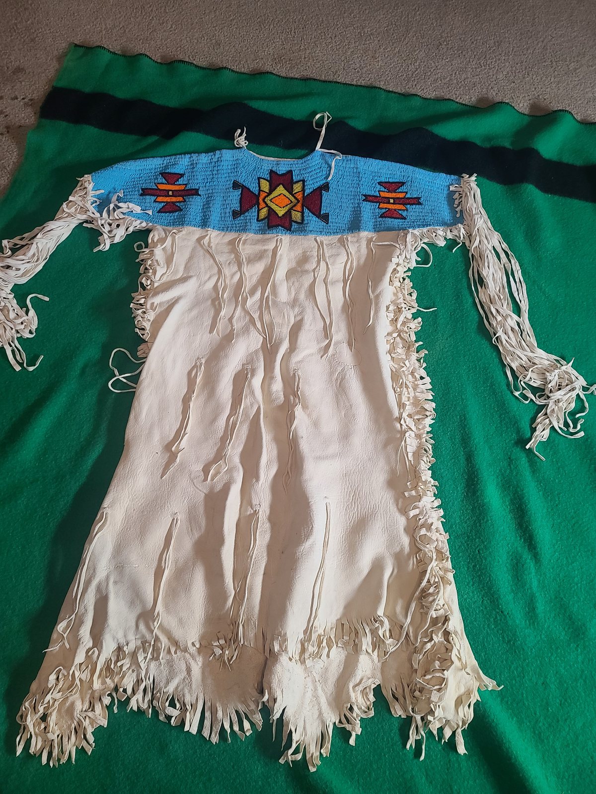 Beaded-yoke buckskin dress, light blue lane-stitch ground