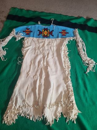 Beaded-yoke buckskin dress, light blue lane-stitch ground