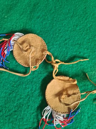 Matched pair of pictorially beaded eagle rosettes (hair ties / regalia ornaments), plate 107