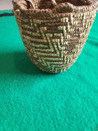 Imbricated coiled cedar-root berry basket with looped rim and buckskin ties, plate 179
