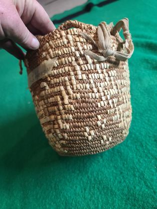 Imbricated coiled cedar-root berry basket with looped rim and buckskin ties, plate 182
