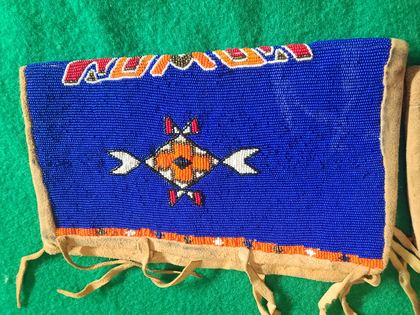 Matched pair of fully-beaded hide cuffs, cobalt field with crossed-arrow medallions, plate 81